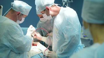 Team of surgeons doing operation in hospital photo