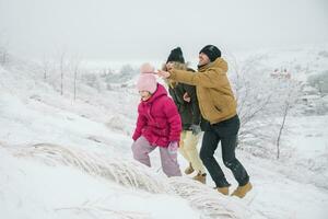 family climbs the hill and having fun photo