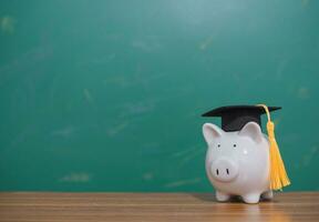 Piggy bank with graduation hat. Copy space for text, Back to school, Education concept photo