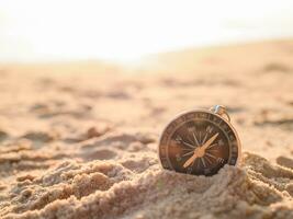 Close up hand holding compass with beach background. The concept of world tourism day, Searching the right directions and Travel photo