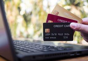 Woman hand holding several credit cards. The concept of Convenience in the world of technology and the internet, Online shopping, banking transaction, banking online and payment photo