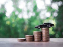 Close up of toy car on stack coins. The concept of saving money and manage to success transport business photo