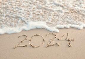 2024 year written on the beach in the sunset time. New Year 2024 concept photo