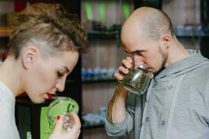 The seller offers to smell tea to the client photo