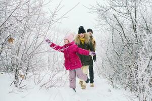 happy family walking on the snowy woods photo