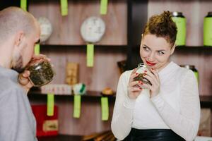 The seller offers to smell tea to the client photo