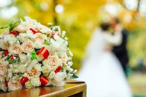 Bridal bouquet on a background of blurred silhouette of a bride with the groom photo