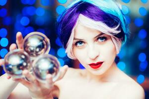 beautiful girl demonstrates juggling with transparent balls photo