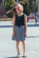 sad little girl on the street with a clown nose photo