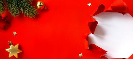 Christmas banner. Christmas tree branch decorated golden color balls and stars on red background. Wide Xmas banner mockup, header, flyer photo