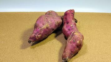 Two purple sweet potatoes on a white background photo