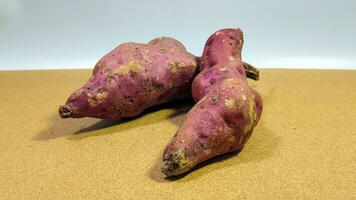 Two purple sweet potatoes on a white background photo