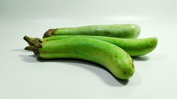 Fresh green eggplant on white background photo