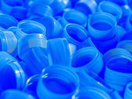 Top view Blue plastic bottle caps.Recycling collection and production processing plastic bottle caps background photo