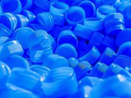 Top view Blue plastic bottle caps.Recycling collection and production processing plastic bottle caps background photo