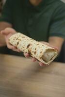 Homemade falafel in pita in hands. photo