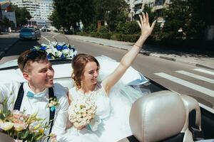 the bride and groom are photographed in the car photo
