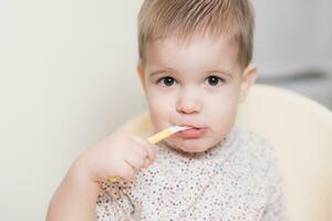 the kid in the kitchen eats milk porridge photo