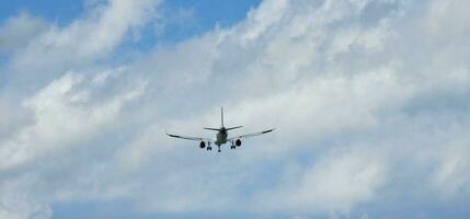 airplane beginning its descent with the landing gear lowered ready for landing photo