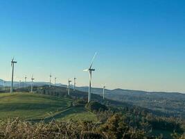 view of a wind farm on top of a mountain. photo