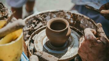 Master hands makes a pot of clay. Master class is held in nature, close-up photo