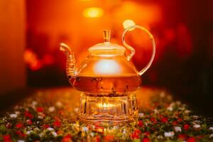 green tea brewed in a transparent teapot is on the table in a cafe photo