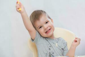 the kid in the kitchen eats milk porridge photo