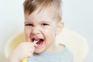 baby in the kitchen eating fruit puree photo