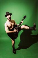 naked guy playing guitar in studio photo