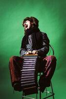 a very positive man with an accordion posing in the studio photo