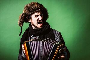 a very positive man with an accordion posing in the studio photo