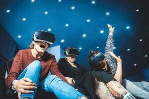 friends in virtual glasses watching movies in the cinema with special effects in 5d photo