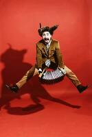 a very positive man with an accordion posing in the studio photo