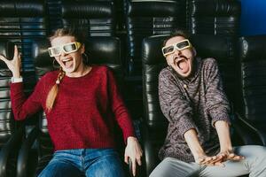 guy and girl 3d glasses are very worried while watching a movie in a cinema photo