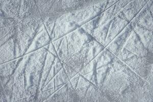traces on the ice from skates on the rink photo