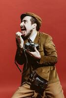 very positive photographer posing in studio with film camera photo