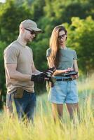 the instructor teaches the girl to shoot a pistol at the range photo