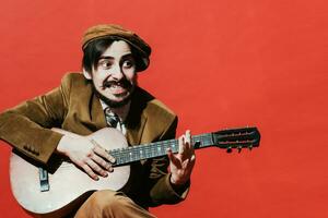 positive guy playing guitar in the Studio photo