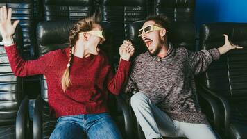 guy and girl 3d glasses are very worried while watching a movie in a cinema photo