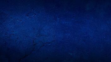 blank blue texture surface background with dark corners. blue grainy cement wall background with space for text. photo