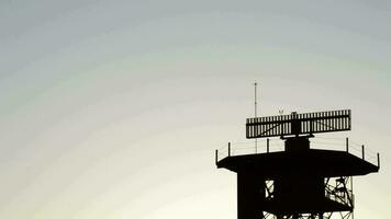 radar girando dentro telecomunicações torre às pôr do sol video