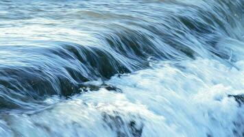 Water river in a little waterfall at sunset video