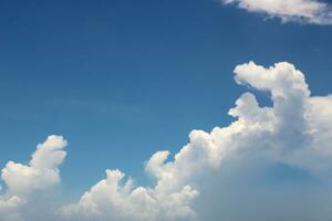 Fluffy White Cloud Against Blue Sky photo