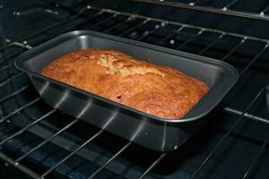 Banana Bread in Pan on Oven Grill photo