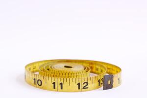 Yellow Tape Measure on White Background photo