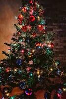 Christmas tree with multi-colored shining garland. photo