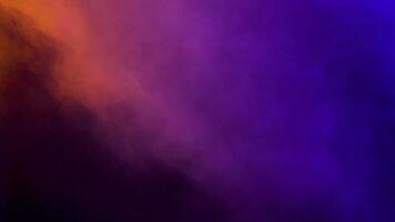 Moving clouds of abstract colorful smoke over a black background video