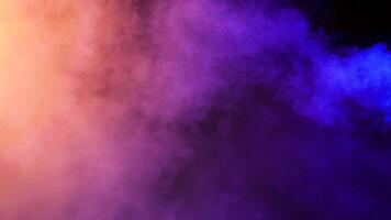 Beautiful abstract colorful smoke clouds over a black background in studio video