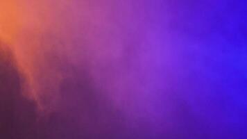 Beautiful dynamic abstract colorful smoke clouds over a black background video