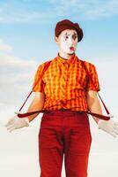 Mime shows pantomime against the blue sky photo